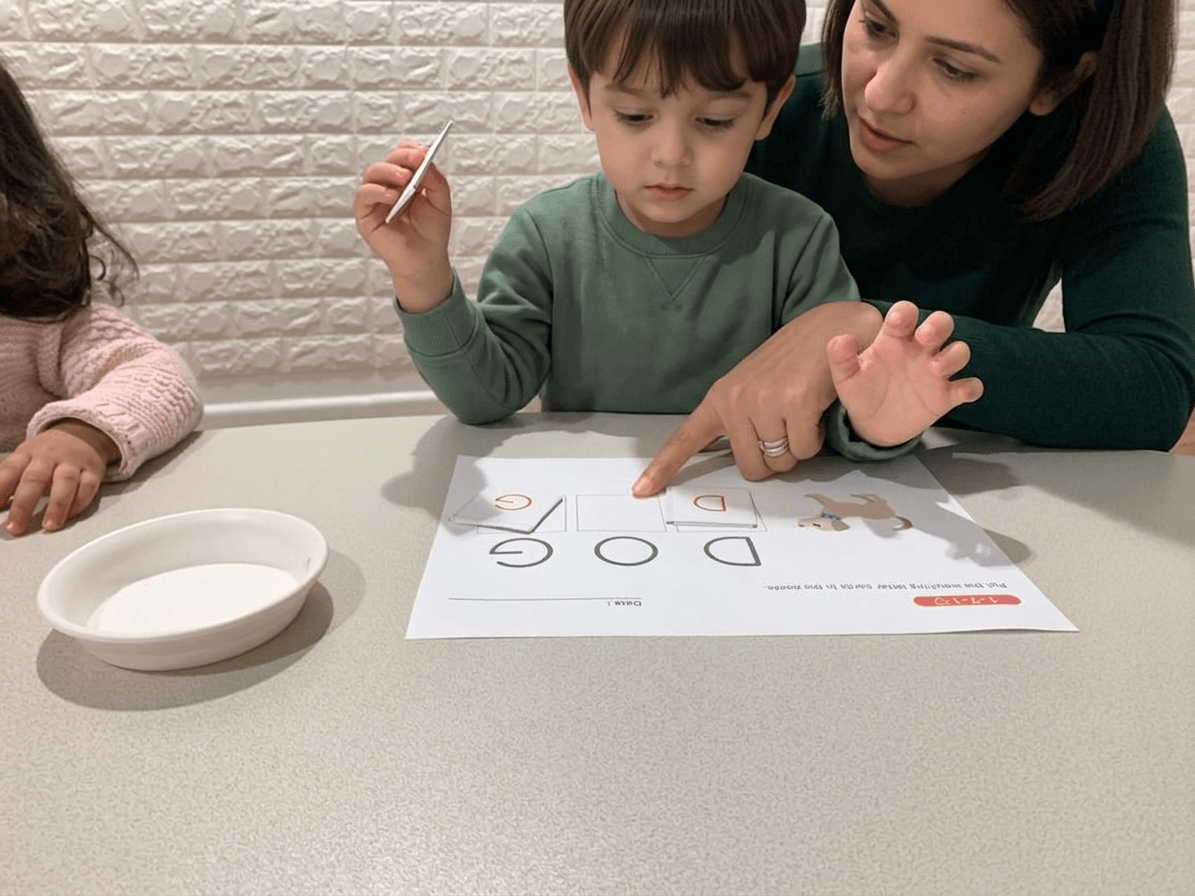 Parent gently guiding their baby through a sensory activity in a Shichida class